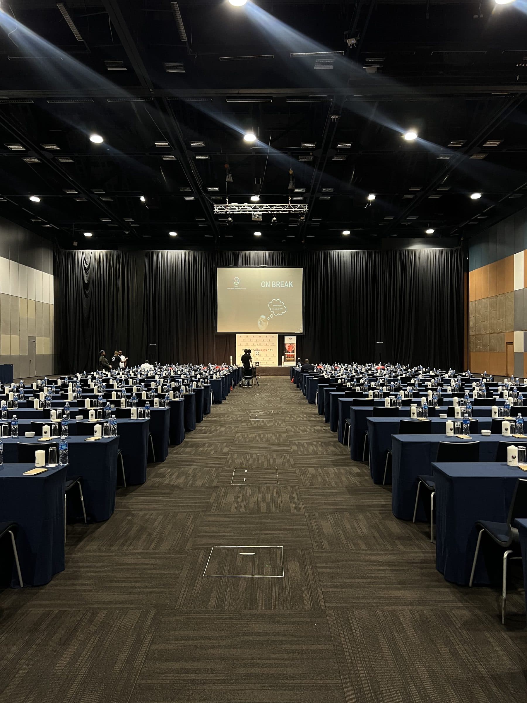 Vast conference hall at the Durban ICC with rows of navy-draped delegate tables